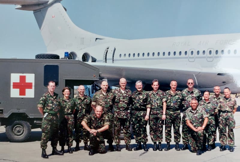 Members of the RAF Aeromedical Evacuation Squadron in front of a field ambulance and aircraft