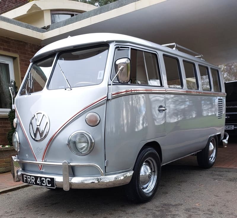 A silver classic Volkswagen camper converted into a hearse